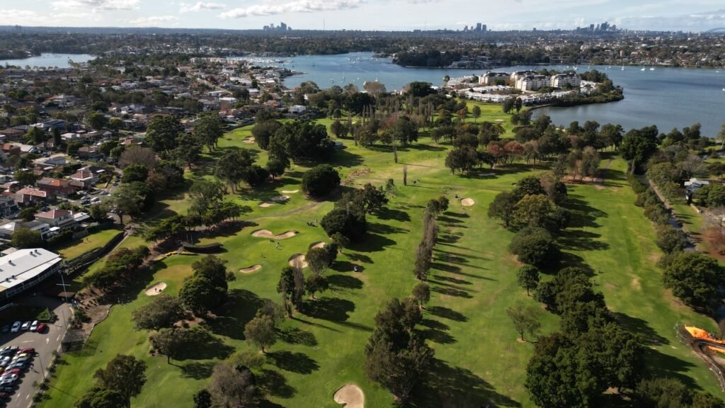 Aerial view of Massey Park Golf Club beside Exile Bay