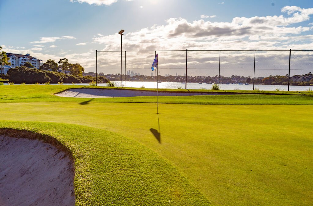 Tree-lined green at Massey Park Golf Club