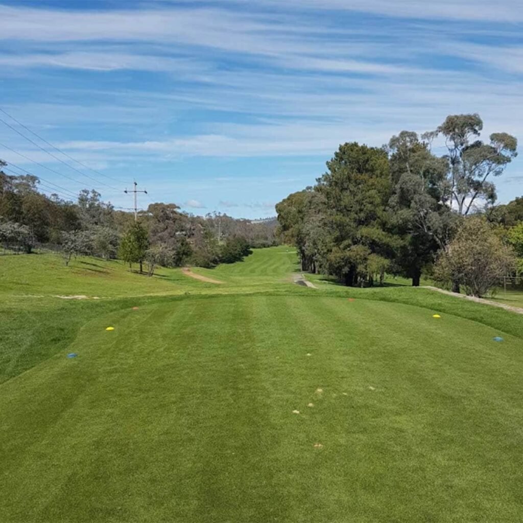 Elevated tee looking down a rolling Queanbeyan fairway