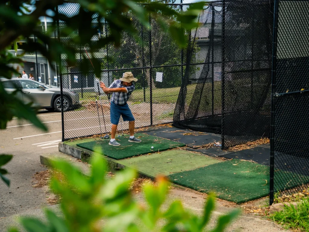 Golfer warming up in the practice net at Randwick Golf Club